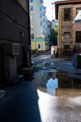 Fototapeta na wymiar cityscapes in reflections in puddles after rain