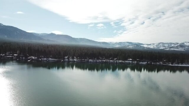 Lake Tahoe Drone Footage. Hills, Trees, Snow, Overlooking parts of Lake Tahoe and Cabin.