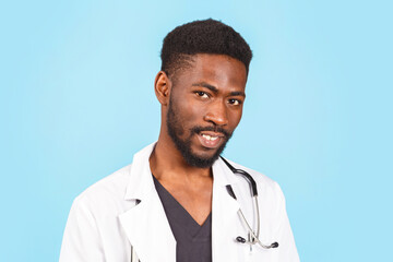 medicine, profession and healthcare concept. African american male doctor with stethoscope in white coat on blue background