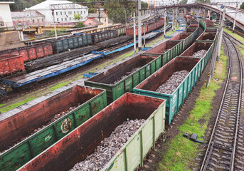 Odessa, Ukraine - October 13, 2016: Heavy industry - coal, metal, square iron pipe is transported in railway freight wagons of the train yard