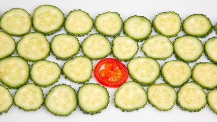 sliced ​​pieces of cucumber and tomato on a white background. fast food and breakfast