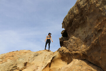 Fit woman girl hiking looking  on mountain top with ocean view landscape catalina island sourthern california