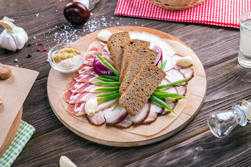 Russian appetizer for vodka. Lard and rye bread. Meat platter. Food background