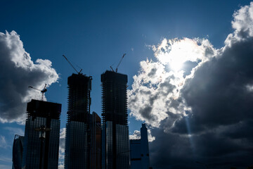 high-rise buildings reflections of sky and clouds and pre-storm sky in summer