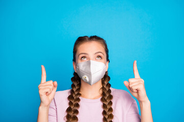 Close-up portrait of her she nice attractive healthy girl wearing safety mask pointing forefingers up therapy treatment disease syndrome isolated over bright vivid shine blue color background