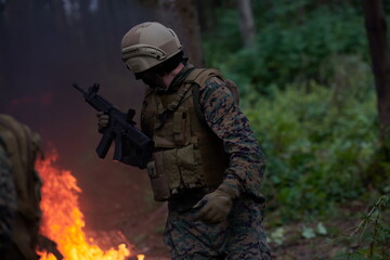 Soldier in Action at Night jumping over fire