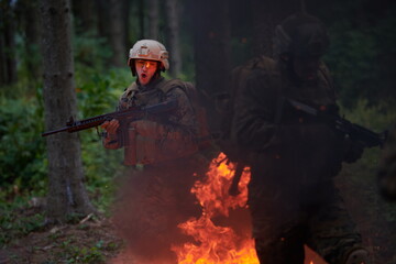 Soldier in Action at Night jumping over fire