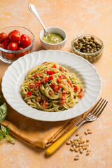 spaghetti with pesto sauce tomatoes fres and capers