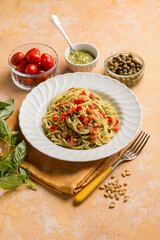 spaghetti with pesto sauce tomatoes fres and capers