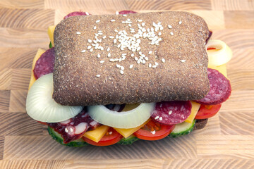 Hamburger with vegetables and sausage. Fast food and breakfast. Calories and diet.