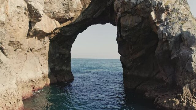 Stone Archway in Gaztelugatxe with Deep Blue Ocean Horizon and Blue Sky