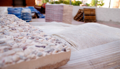 pallets with construction tools, tiles and sand