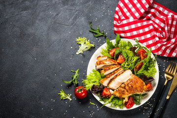 Grilled chicken with fresh salad at black.