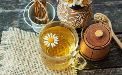cup of herbal chamomile tea and daisy flowers. doctor treatment and prevention of immune concept, medicine - folk, alternative, complementary, traditional medicine
