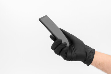 Phone in hand with a black medical glove.