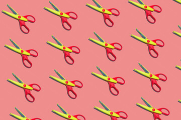 Open plastic yellow and red scissors on pastel pink color background. Seamless colorful pattern.