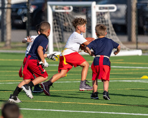 Cute athletic little boy playing excitedly in a flag football game