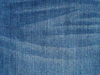 Washed denim jeans fabric background, blue plain surface texture