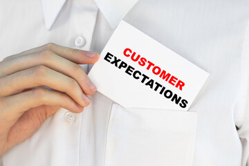 Businessman putting a card with text Customer Expectations in the pocket