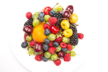 assortment of fresh berries on a white plate. useful vitamin healthy food fruit. healthy vegetable breakfast