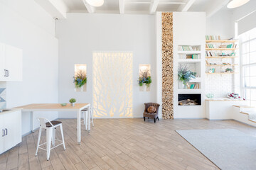 Fashionable spacious apartment with a stylish design in green, grey and white pastel colors with big window and decorative walls. bedroom and kitchen space