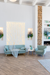 Fashionable spacious apartment with a stylish design in green, grey and white pastel colors with big window and decorative walls. bedroom and kitchen space