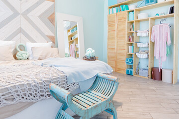 Fashionable spacious apartment with a stylish design in green, grey and white pastel colors with big window and decorative walls. bedroom and kitchen space