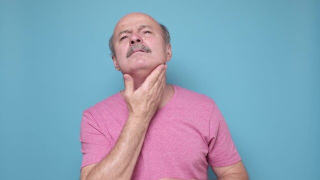 Elderly man suffering from throat problems