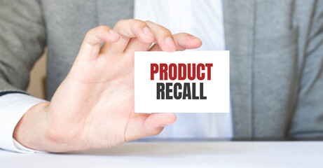 Businessman holding a business card with text Product Recall