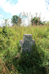 Old stone cross on abandoned cemetery