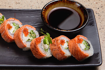 Sushi. Various rolls on a plate with soy sauce.