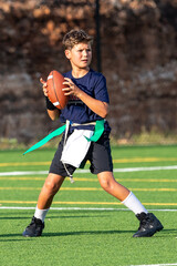 Young athletic boy playing in a flag football game © Joe