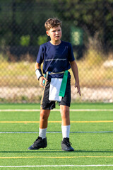 Young athletic boy playing in a flag football game