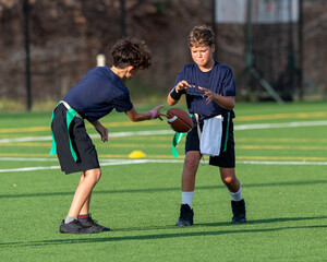 Young athletic boy playing in a flag football game