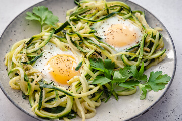 fried egg in zucchini noodle nest, healthy breakfast
