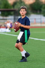 Young athletic boy playing in a flag football game