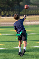 Young athletic boy playing in a flag football game