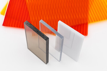 Solid Polycarbonate Sheet. Brown and transparent. Acrylic Plastic glass. Colored pc sheet on background
