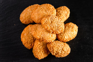 Chicken fried nuggets on a dark background. Fast food concept