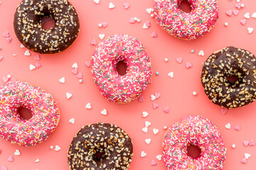 Colorful donuts pink and chocolate icing. Flat lay of bakery, above view