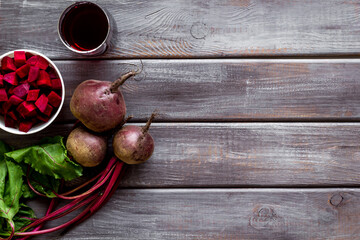 Top view of beet harvest. Green tops, slices, juice top-down space for text