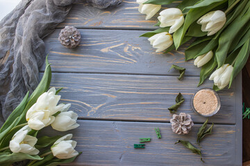 White tulips on a blue wooden background. Top view with copy space.