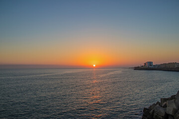 The orange sun sets over the horizon. Atlantic Ocean. Spain