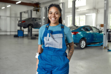 Perfect service. Portrait of young african american woman, professional female mechanic in uniform...