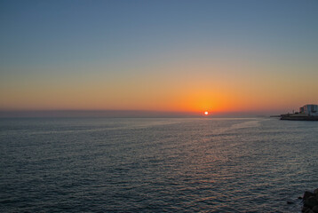 The orange sun sets over the horizon. Atlantic Ocean. Spain