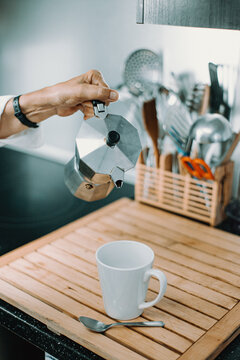 An Old Woman About To Serve Some Coffee