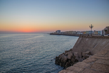 The orange sun sets over the horizon. Atlantic Ocean. Spain