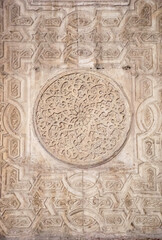 ancient stone wall with carved stone, detail of mosque wall at Cairo, Egypt. Religious ornaments. Interior detail. Arabic design. 