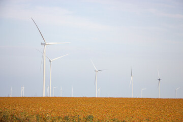 Wind turbines against the backdrop of a cloudy sky, windmills that generate electricity are installed in the steppe.