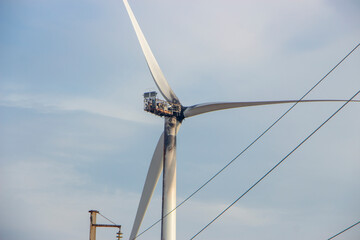 Fire at the wind farm, destroyed windmill, burned wind generator. Power lines.